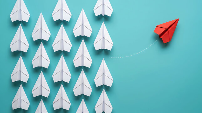 Red paper airplane breaking away from white fleet for leadership concept