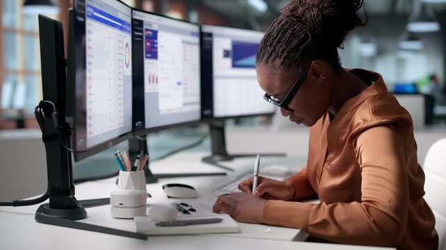 Financial Analyst Reviews Corporate Budgets Using Software