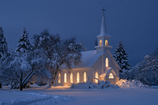 White Church Covered in Snow on a Peaceful Winter Evening
