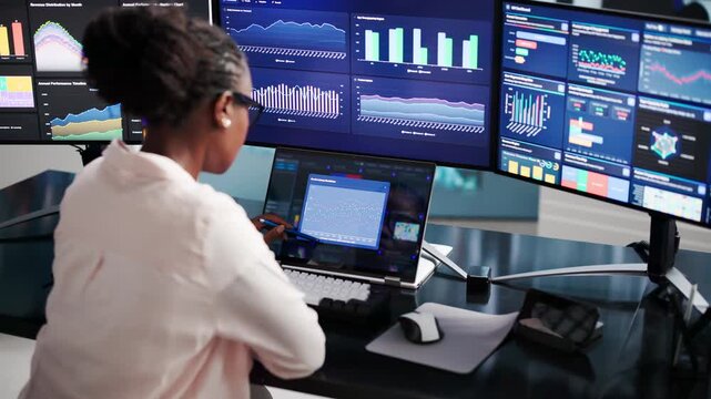Financial Analyst Reviewing KPI Dashboard On Laptop