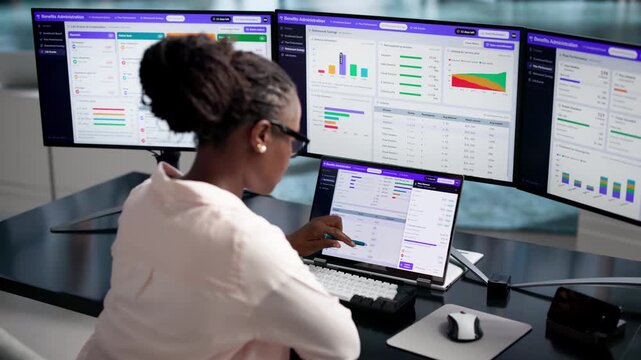 Human Resources Manager Reviews Employee Benefits Data