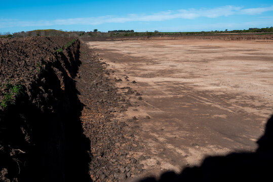 Large scale excavation and earthworks for retention basin at construction site