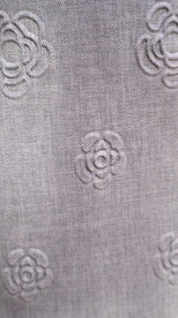 Grey fabric with embossed floral pattern