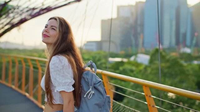 Tourist woman strolling in Gardens by the Bay Singapore admiring tropical park landscapes and impressive cityscape in the heart of a dynamic Asian metropolis