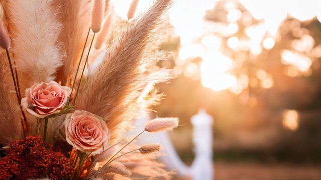 Boho autumn floral arrangement with pampas grass and blurred wedding background banner.