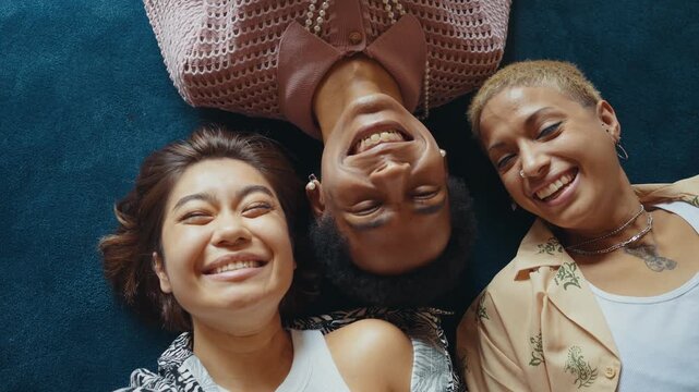 Group of friends bonding at home, LGBTQ and diversity concepts - Homosexual couple and fluid gender non binary young man with cross dressing clothing style having fun in the apartment, LGBT people