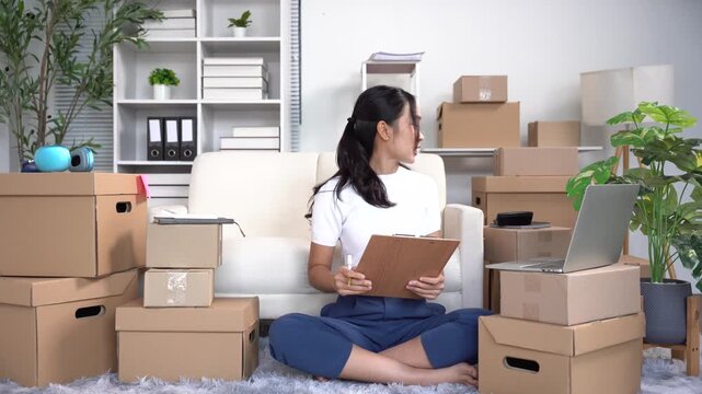 Woman working from home with boxes