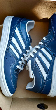 Sosnovy Bor, Russia &mdash; July, 11, 2026: New blue sneakers Dinamo with white stripes placed in a box in Russia