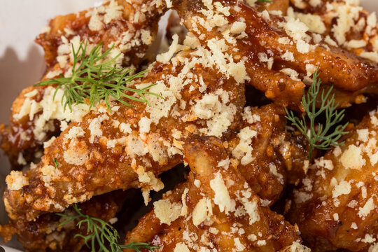 Appetizing Close-Up of Spicy Chicken Wings Topped with Crushed Parmesan Cheese, Crispy and Savory Flavor