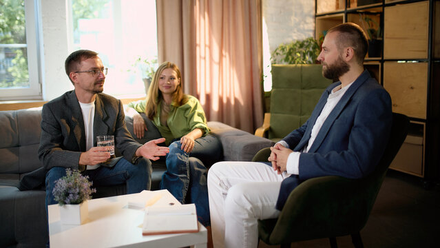Couple discussing relationship goals with male family psychologist. Concept of shared goals, partnership planning, relationship growth, family wellbeing.