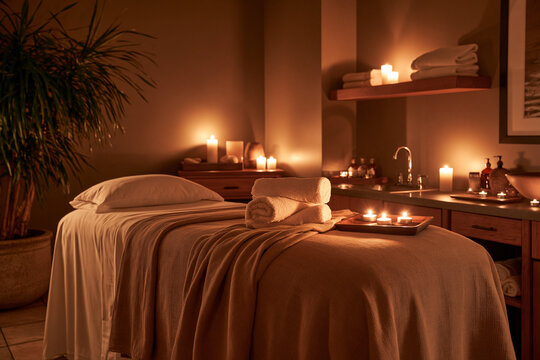 Tranquil Spa Room with Candles and Massage Bed Ready for Relaxation.