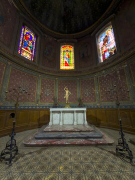 Stained-glass windows and marble altar in the former hospital chapel, now home to Le Village des Brocs antiques market, Gers, Lectoure, France