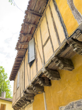Detail of a half-timbered house corner with exposed wooden beams and corbels, Gers, Sarrant, France