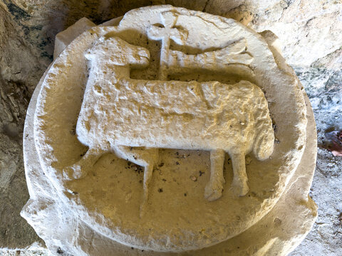 Medieval carved stone relief of a lamb on a column capital at St. Peter collegiate church, Gers, La Romieu, France