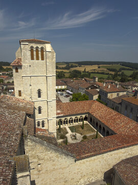 Aerial view of the bell tower and cloister of St. Peter collegiate church overlooking the village, Gers, La Romieu, France