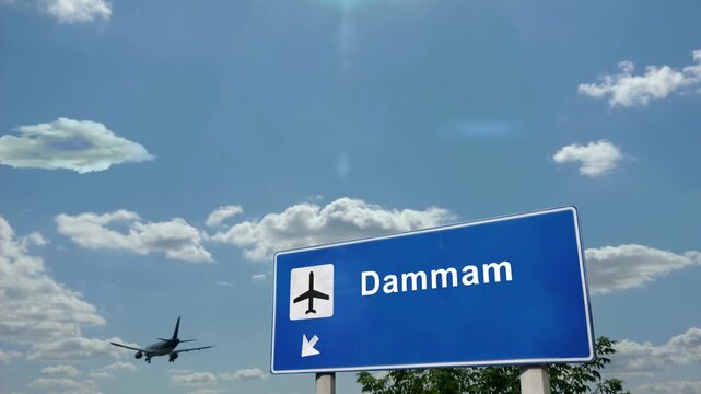 Dammam Saudi Arabia Jet plane landing. City arrival with airport direction sign. Travel, business, tourism and airplane transport concept.