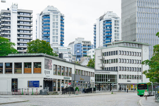 August 15, 2026, Stavanger, Norway - Urban street scene with buildings, electric scooters, and a bus