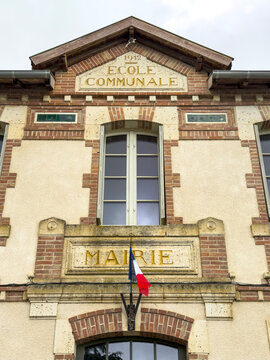 Brick and stone facade of the 1912 communal school and town hall, Gers, Boulor, France