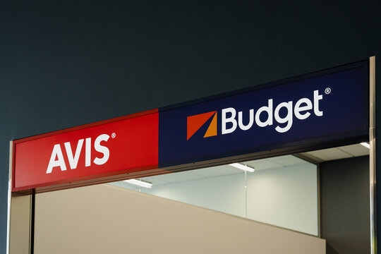 August 15, 2026, Stavanger, Norway - Avis and Budget car rental signs at Stavanger Airport