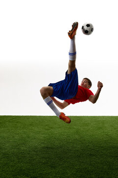 Vertical bicycle kick showing power and full body extension. Concept of athletic strength, overhead technique, flexibility and high impact soccer action.