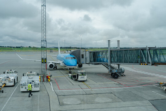 August 15, 2026, Stavanger, Norway - KLM aircraft parked at a gate with a jet bridge and ground support vehicles at Stavanger Airport.