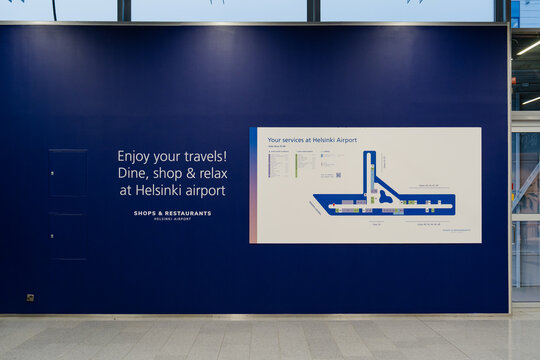 August 15, 2026, Helsinki, Finland - Information wall with airport map and text at Helsinki-Vantaa Airport