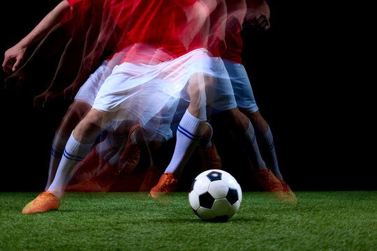 Close motion sequence of soccer feet maneuvering around ball. Concept of footwork drills, close control, speed training and technical football instruction.