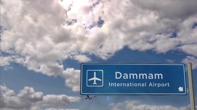 Dammam Saudi Arabia Jet plane landing. City arrival with airport direction sign. Travel, business, tourism and airplane transport concept.