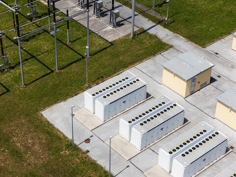 Aerial view of a battery energy storage facility connected to the power grid. Renewable energy systems provide storage solutions.