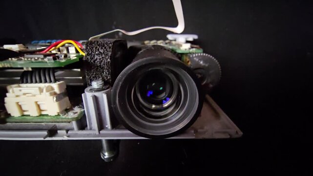 Dissembled Mini Projector Interior with exposed Optical Lens and Circuit Board