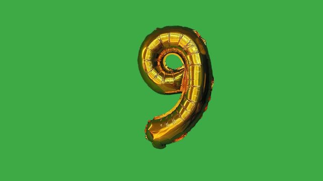 Golden foil balloon number nine on green screen background