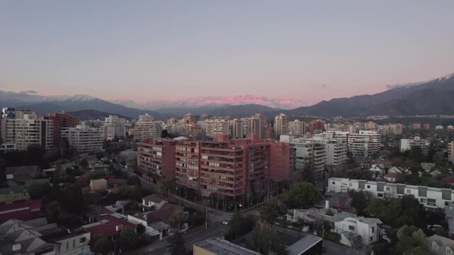 Aerial Drone Rise Over Santiago de Chile Towards Andes Mountains At Sunset