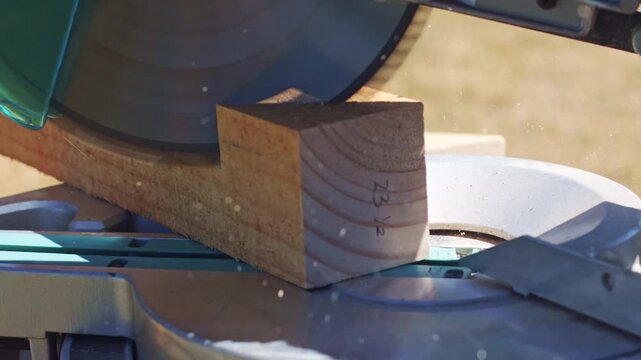 Wood block with pencil measurement mark before miter saw cut