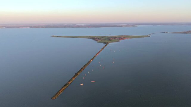 Marken and anchored sailboats beside its long dike