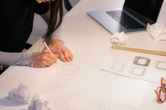 Woman Sketches Design Ideas at a Desk in an Office Space