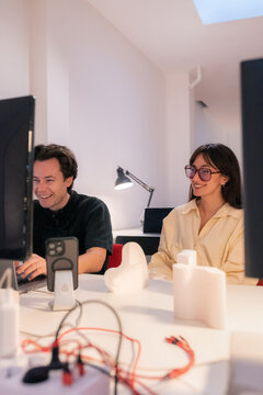 Team Members Work on a Project at a Shared Workspace in the Evening