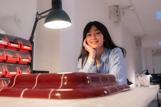 Portrait of designer with her product at workshop