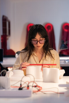 Designer Works on a Project in a Studio During the Daytime