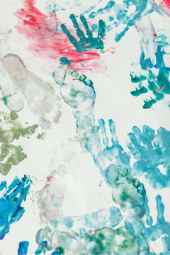 Colorful prints of children's hands and footprints