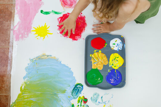 Child having fun with tempera paints