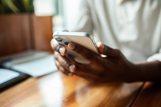 Person using smartphone at cafe table
