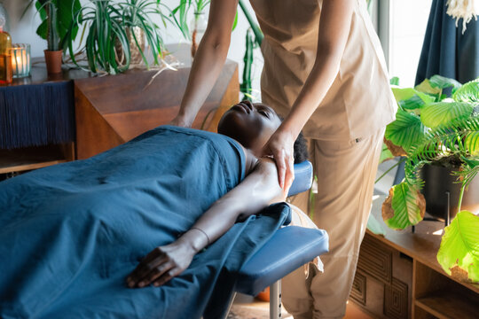 Professional massage therapist working with client