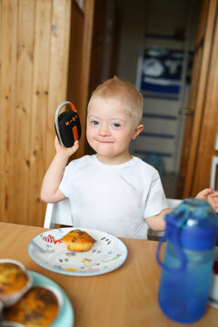 A boy with Down syndrome listening to music.