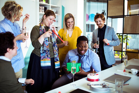 Coworkers celebrating a colleague's birthday in the office