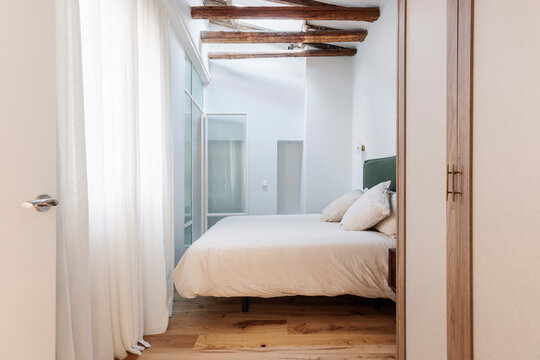 Modern bedroom with wooden beams