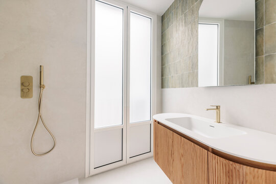 Modern bathroom with curved vanity