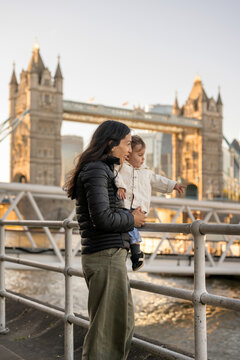 Mother Holding Baby While Visiting Tower Bridge 