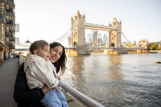 Mother And Baby Smiling Beside Tower Bridge