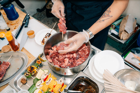 Chef Prepares Skewers With Meat and Vegetables in a Kitchen