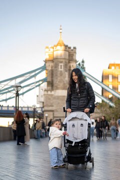 Mother With Baby And Stroller Near Tower Bridge